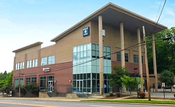 Modern dental office building with brick and tan exterior, large windows, and columned entrance.